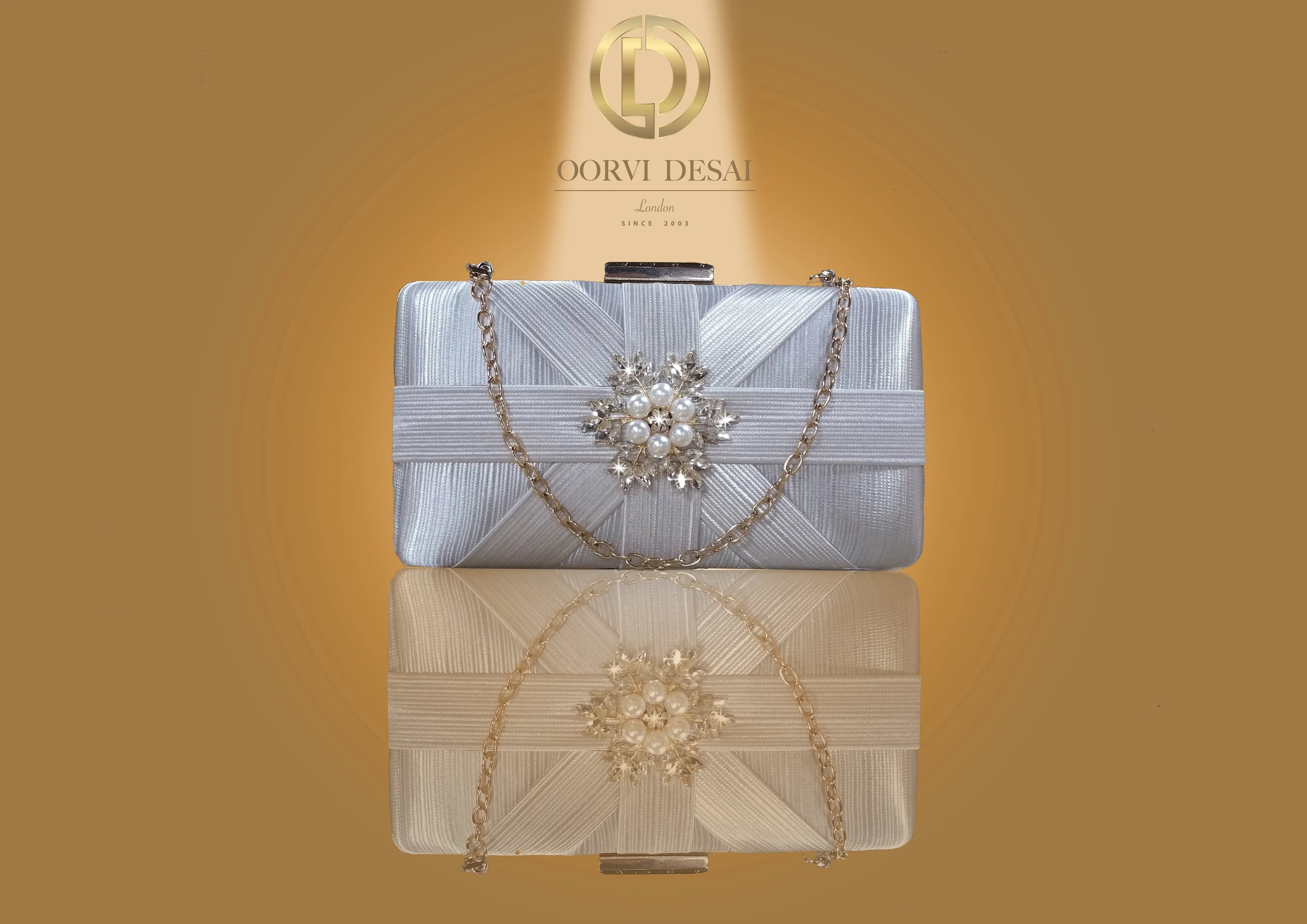 'Lustrous Criss-Cross Patterned Clutch with Pearl Brooch by Oorvi Desai' (OD - B 29  Gold/ Red/ Grey)